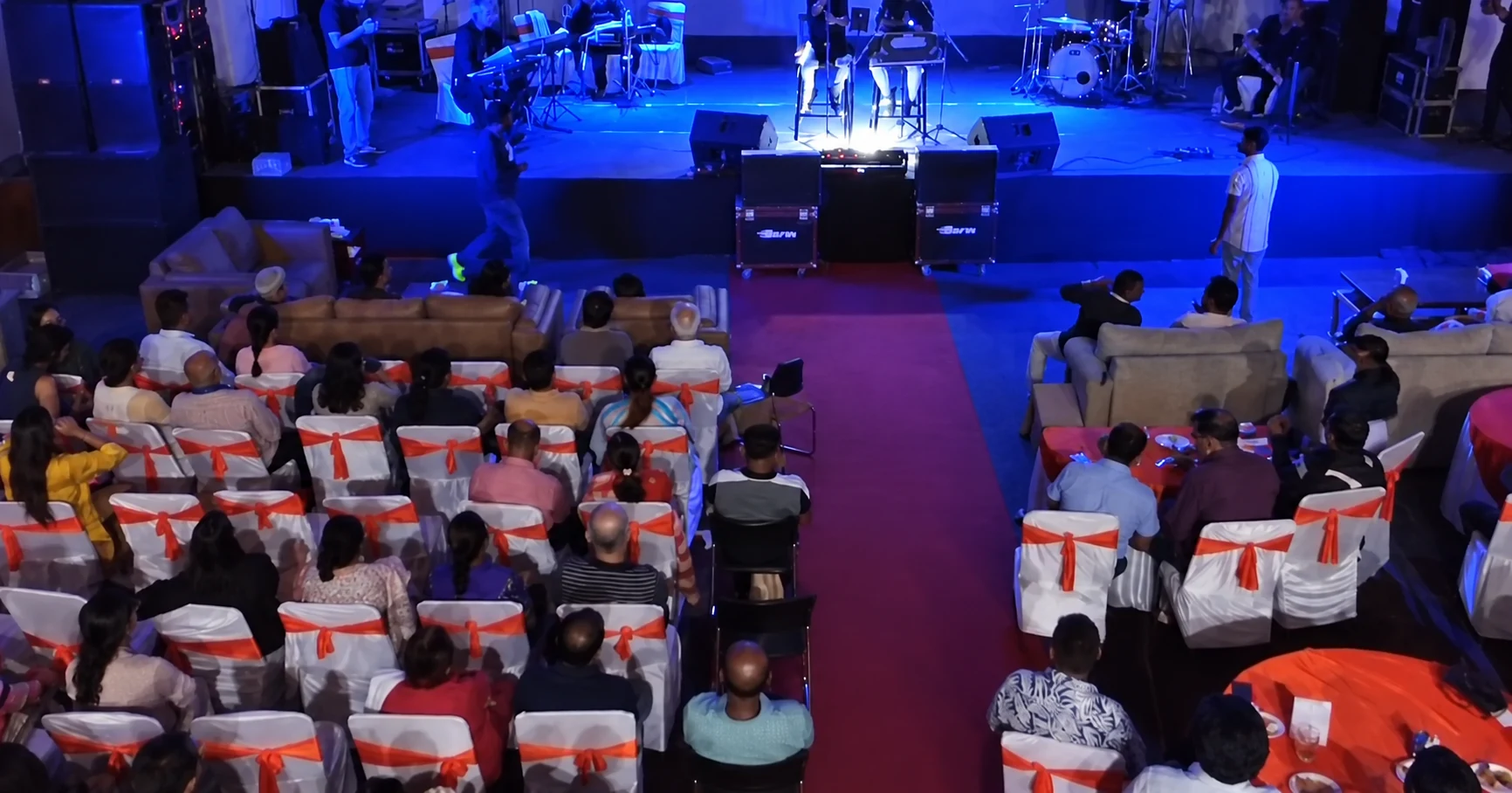 An elevated view of the C2BE audience and the illuminated stage