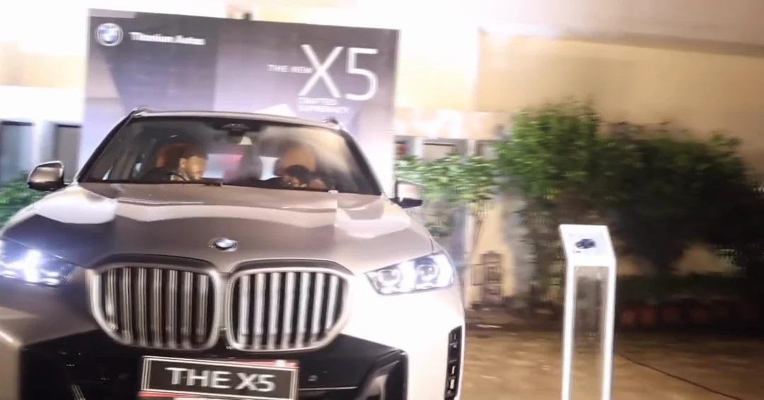 A BMW X5 with guests seated inside at the event
