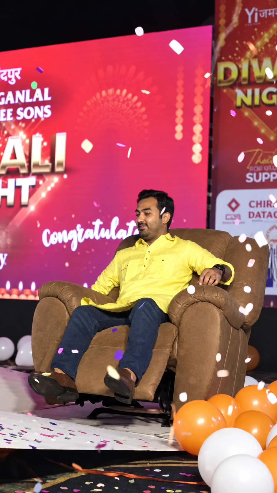 The Tambola Night winner seated in his recliner with confetti falling around him