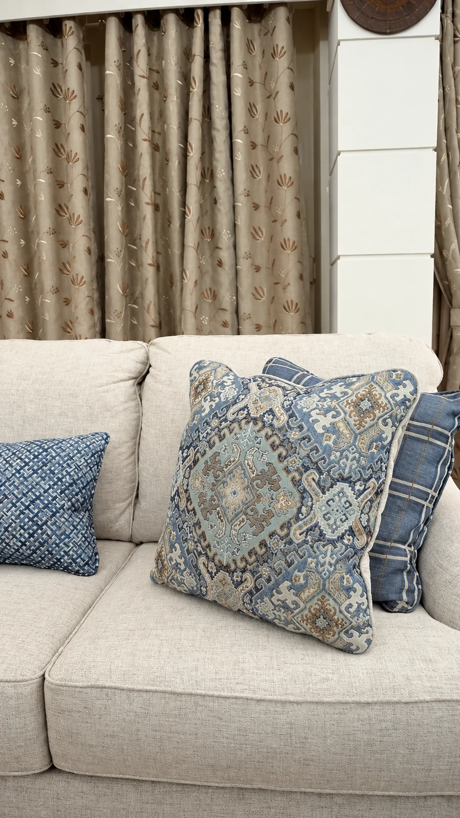 Cream Traemore sofa and patterned blue cushions after installation in a customer’s home