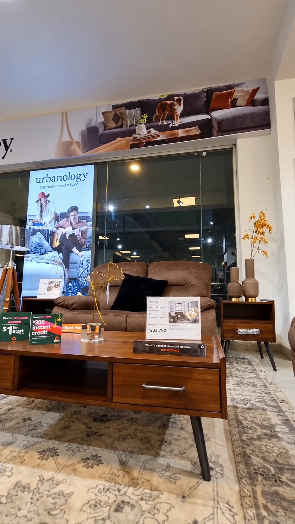 Urbanology brand panel behind leather seating and a coffee table with product cards