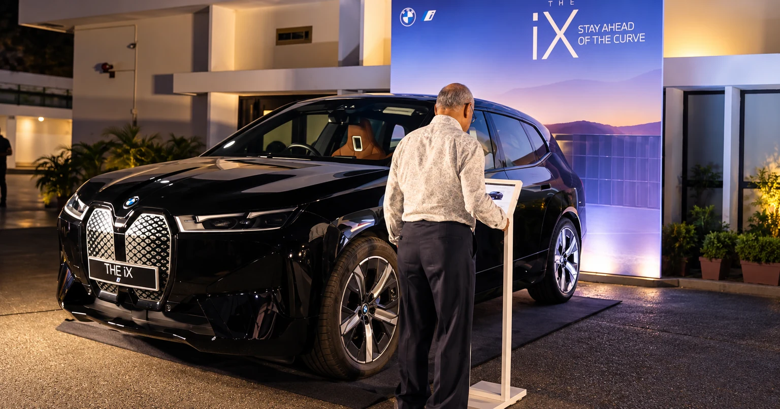 A guest reading the information display beside a BMW iX