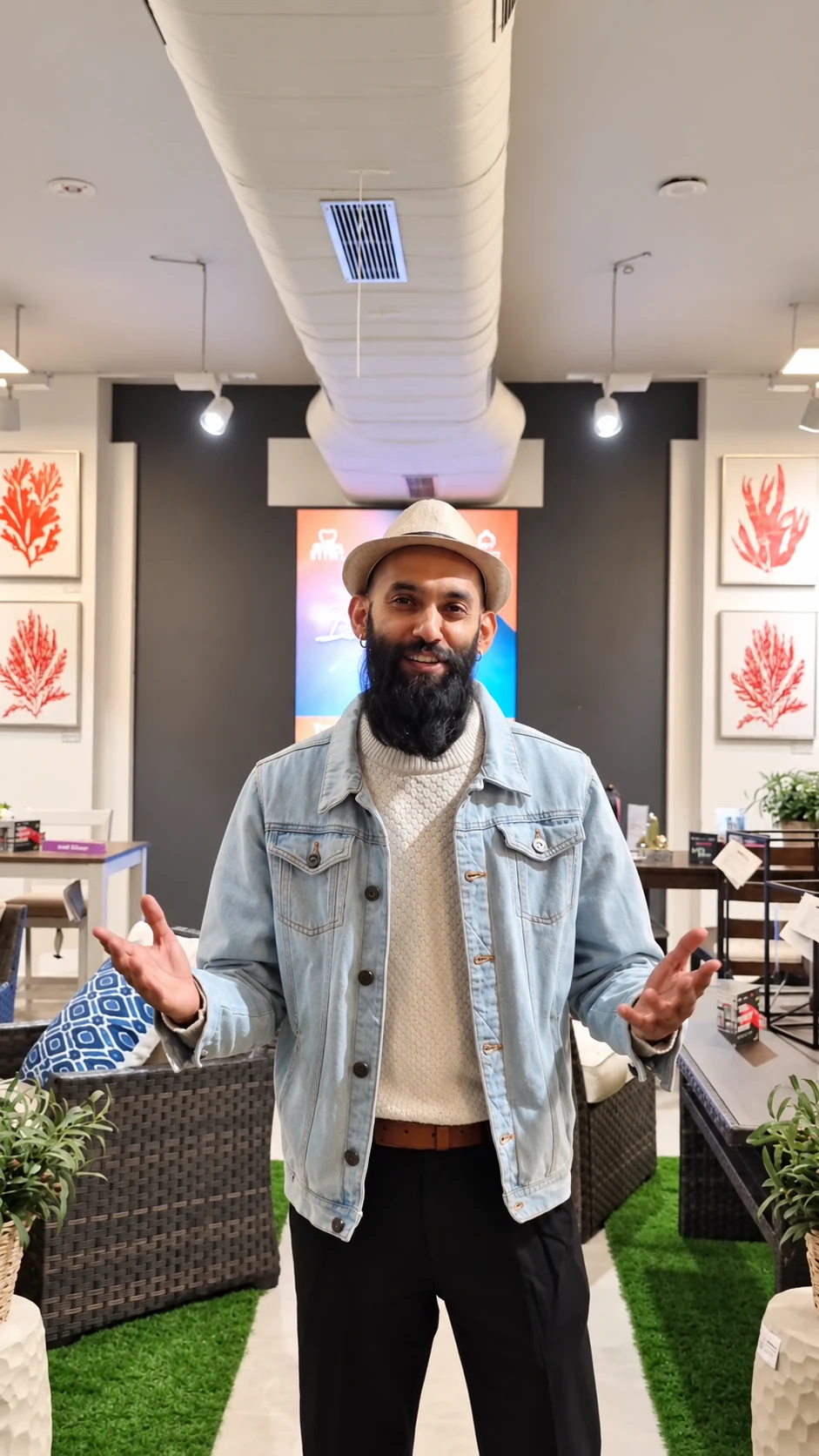 The creator facing the camera and introducing Ashley from inside the showroom