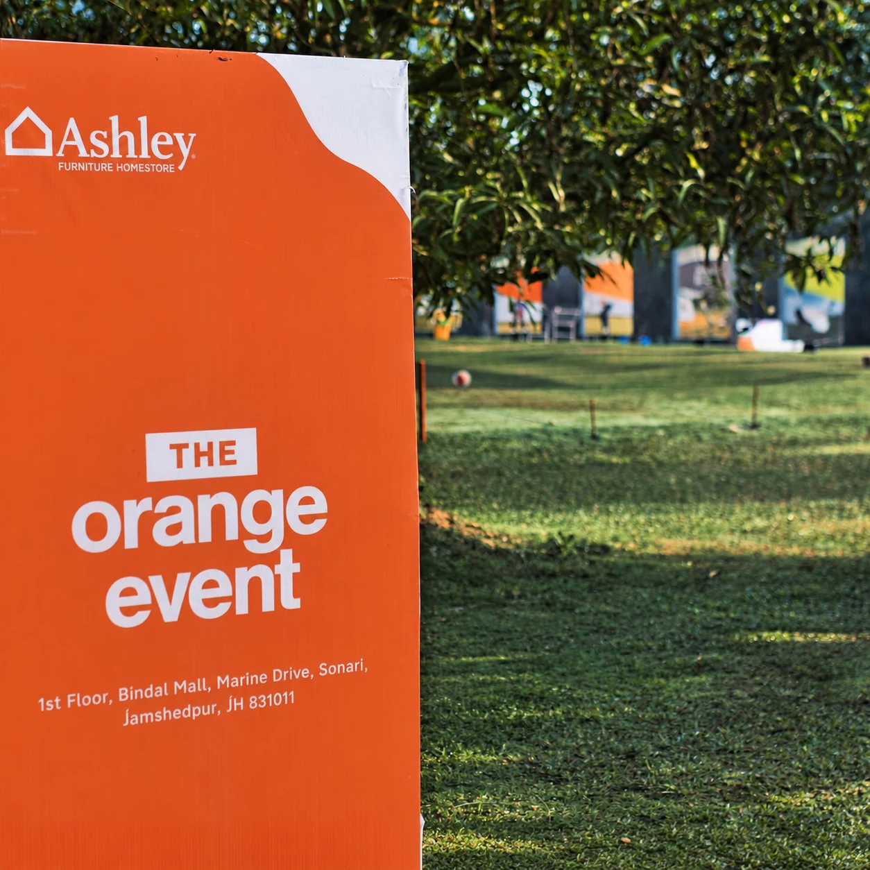 An orange Ashley standee at the golf course promoting the Orange Event and giving the showroom address