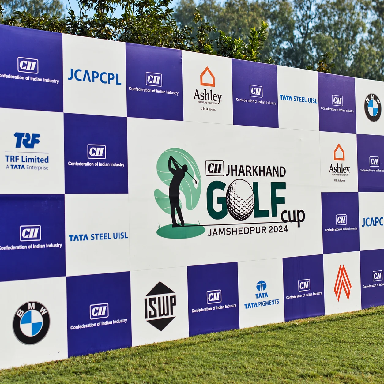 The CII Jharkhand Golf Cup sponsor backdrop showing Ashley, BMW and Tata company logos